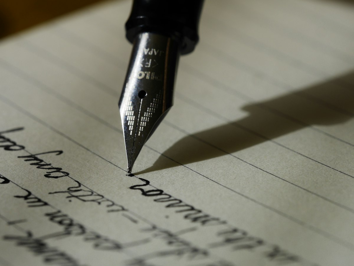 Author writing with fountain pen